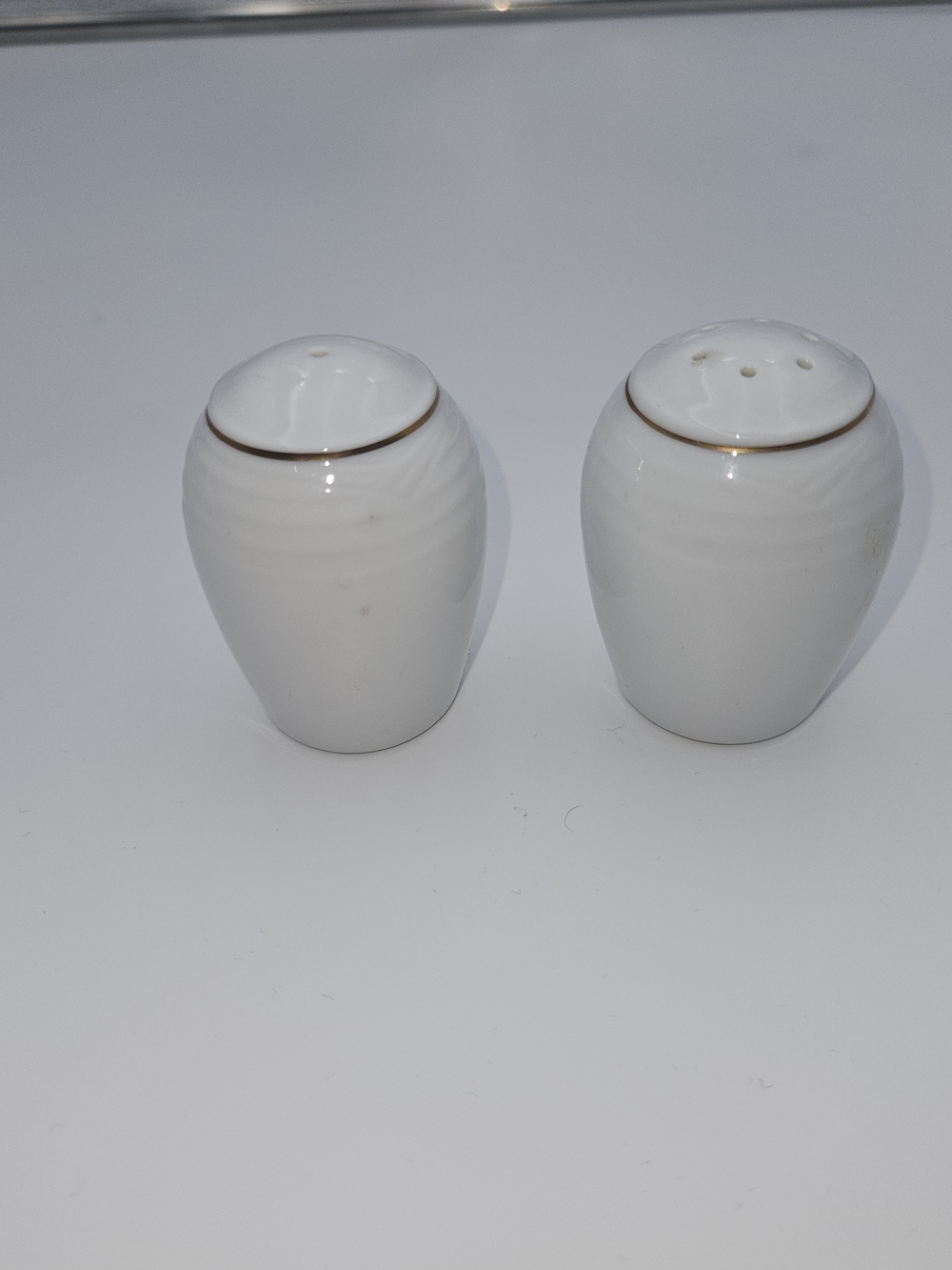 White Ceramic Salt and Pepper Shakers with Gold Rim